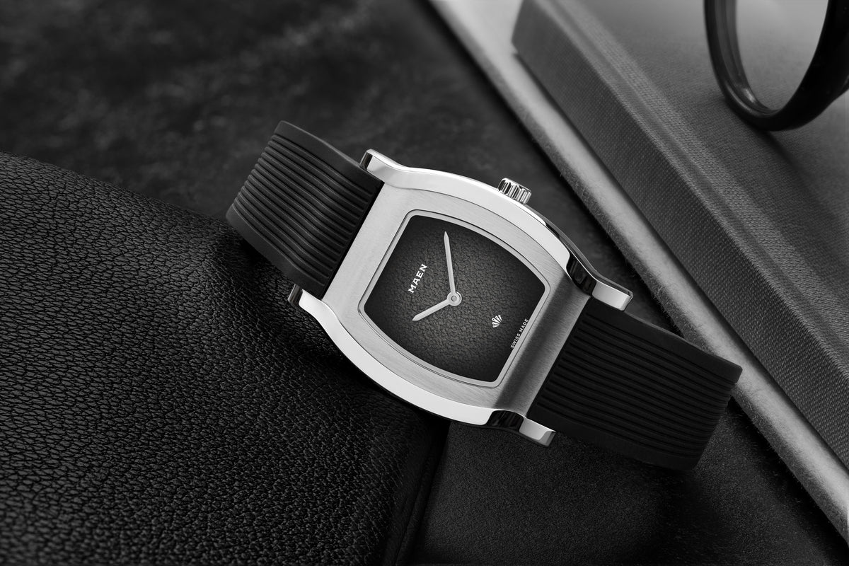 Grand Tonneau Ultra-Thin MNL.04 Black Fumé on its rubber strap, close-up