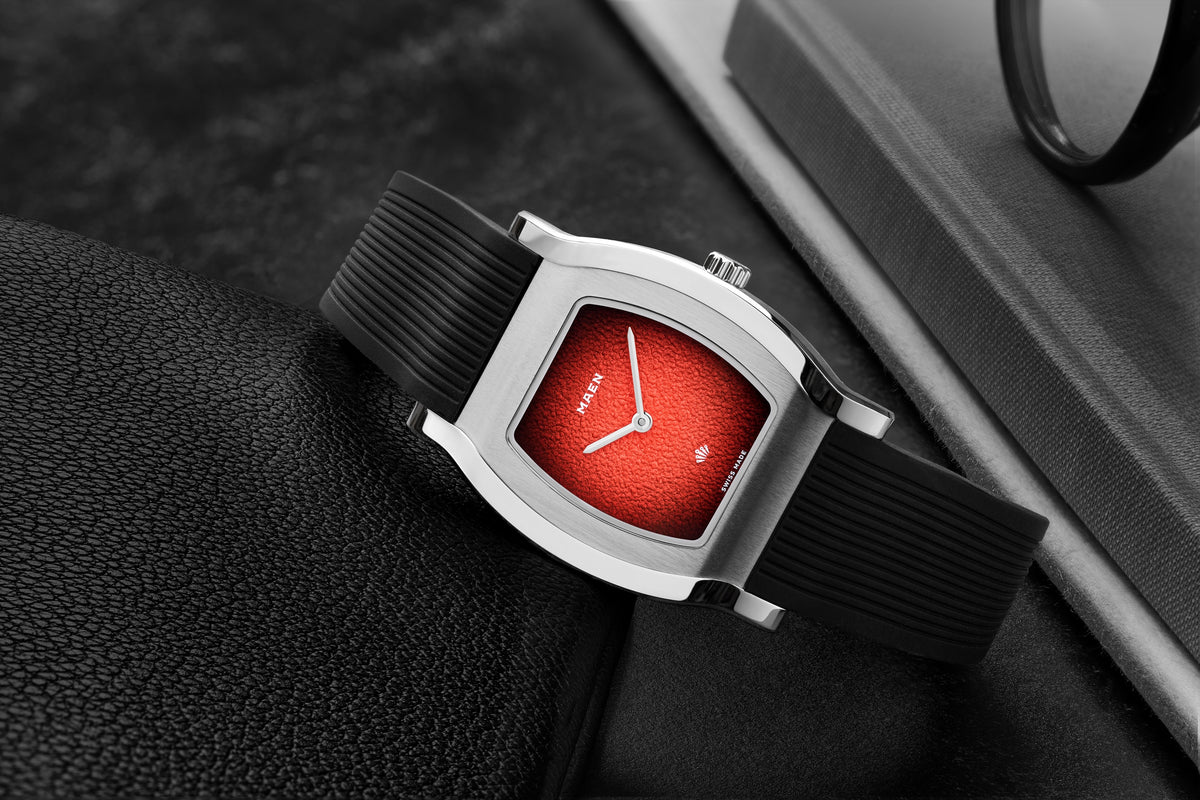 Grand Tonneau Ultra-Thin MNL.05 Lava Red Fumé on its rubber strap, close-up