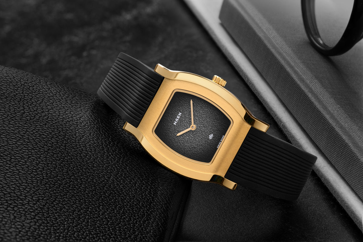 Grand Tonneau Ultra-Thin MNL.06 Black Fumé, gold-plated case on its rubber strap, close-up
