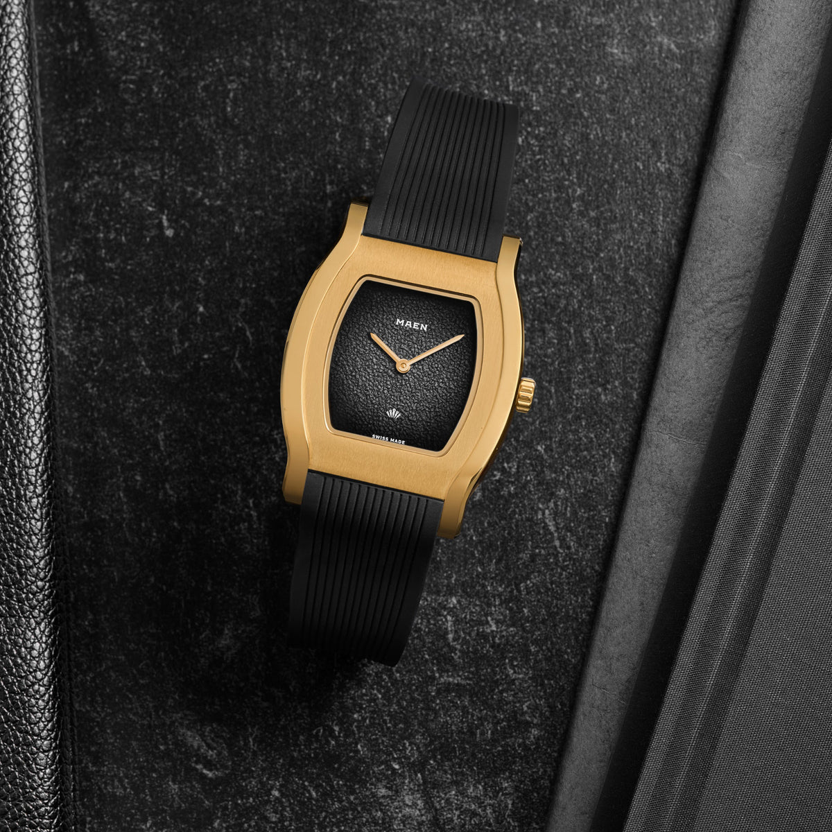 Grand Tonneau Ultra-Thin MNL.06 Black Fumé, gold-plated case on its rubber strap, seen from above