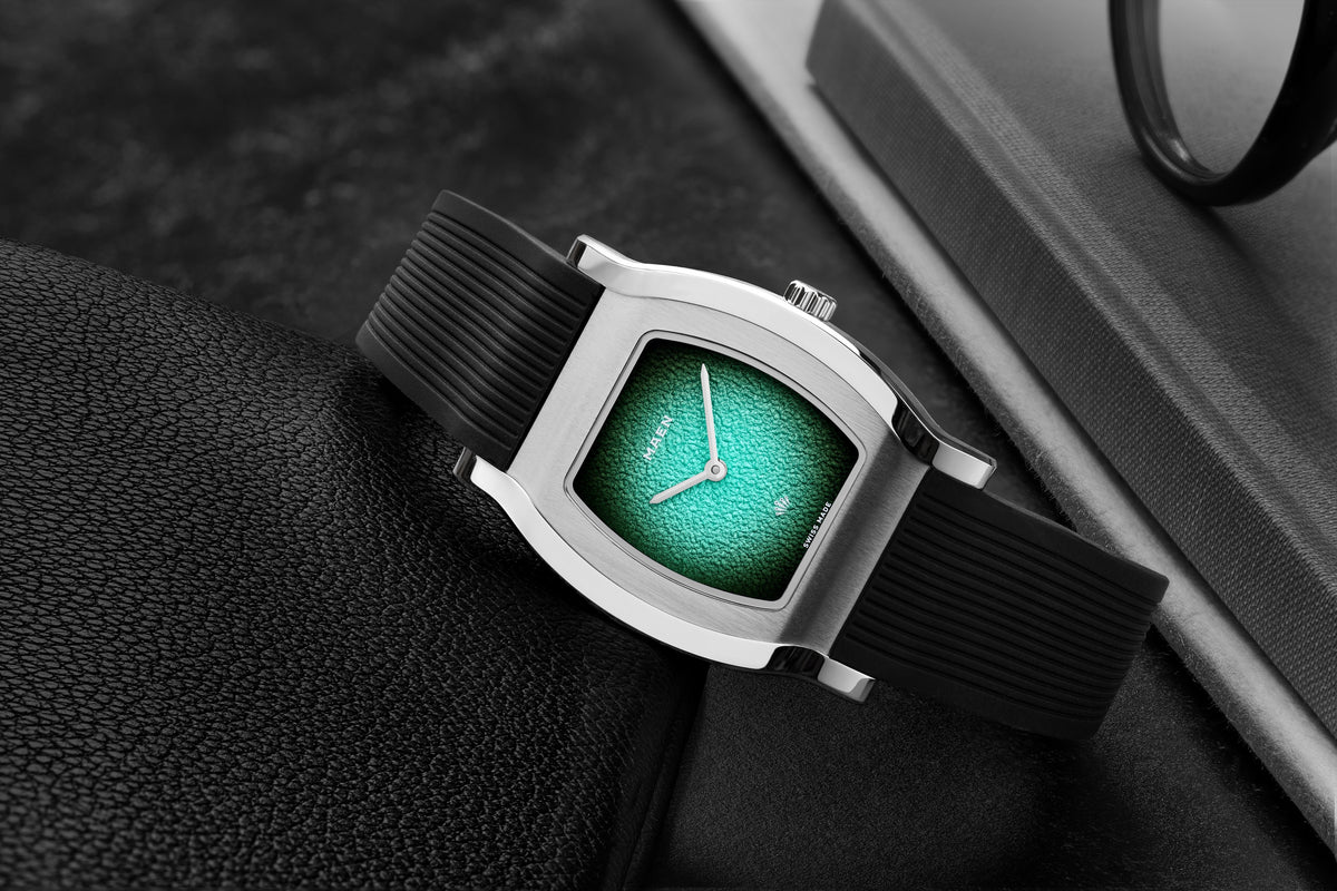 Grand Tonneau Ultra-Thin MNL.07 Turquoise Fumé on its rubber strap, close-up